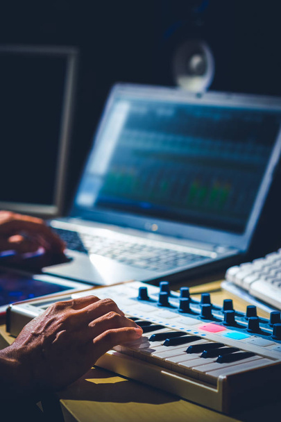 male musician hands recording a song on midi keyboard and laptop computer  - Foto, immagini