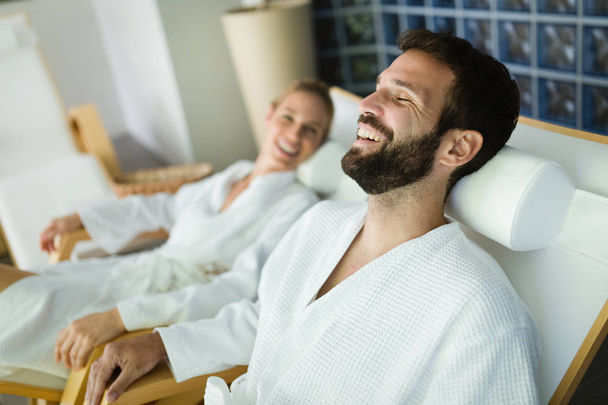 Attractive happy couple relaxing in spa center together - Φωτογραφία, εικόνα
