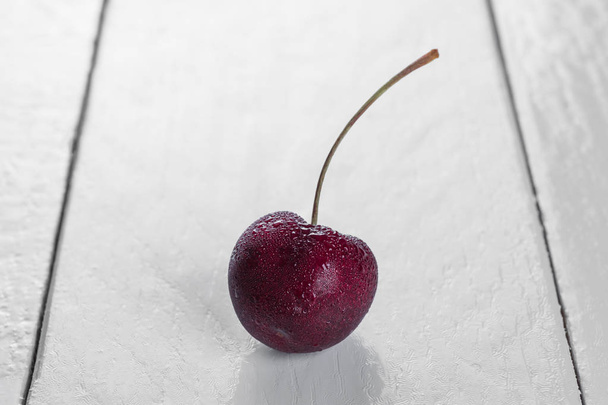 Frutti di ciliegio su tavolo di legno bianco
 - Foto, immagini