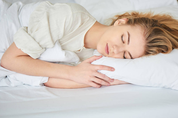 attractive woman peacefully sleeping in bed, close-up  - Valokuva, kuva