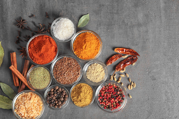Bowls with various spices on grey background - Foto, immagini