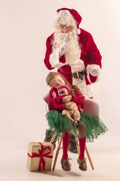 Christmas portrait of cute little newborn baby girl, dressed in christmas clothes, studio shot, winter time - Фото, зображення