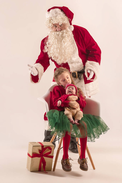 Christmas portrait of cute little newborn baby girl, dressed in christmas clothes, studio shot, winter time - Φωτογραφία, εικόνα