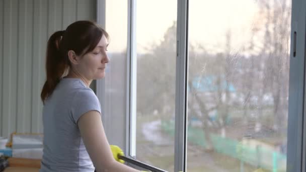 Kobieta w rękawice żółty mycia okna specjalne mop - Materiał filmowy, wideo