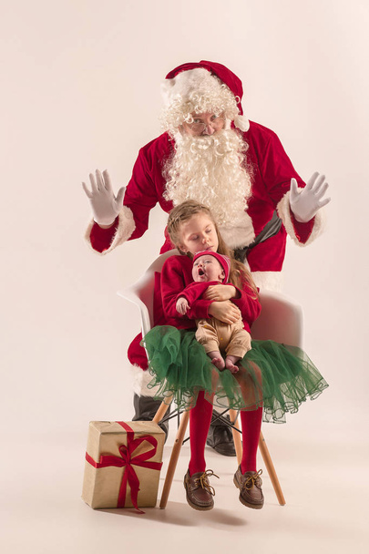 Christmas portrait of cute little newborn baby girl, dressed in christmas clothes, studio shot, winter time - Valokuva, kuva