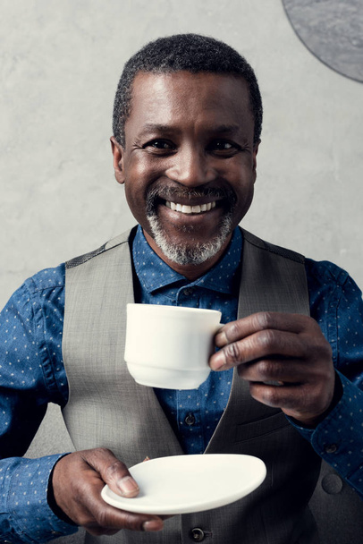 portrait of cheerful african american man with cup of coffee - Fotoğraf, Görsel