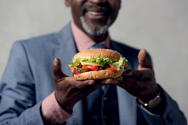 cropped view of african american man with hamburger - Photo, Image