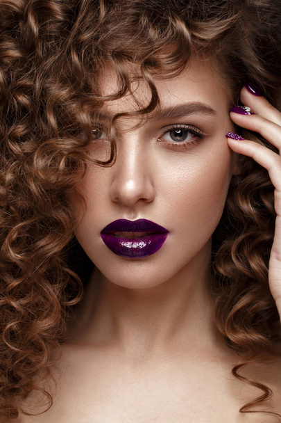 Beautiful girl with evening make-up, purple lips, curls and design manicure nails. beauty face. - Foto, Imagem