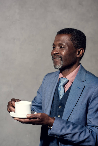 mature smiling african american man with cup of coffee - Foto, Bild