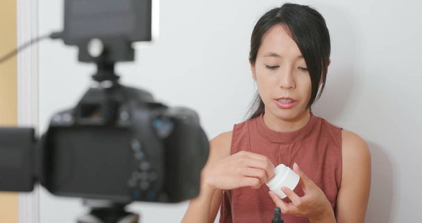 Woman selling the beauty product in front of the camera  - Photo, Image