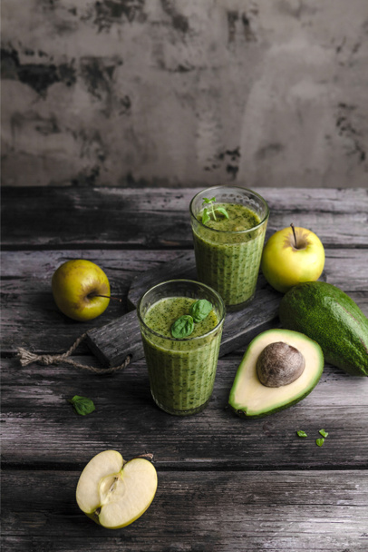 Fresh healthy smoothie with apples and avocado on rustic table - Фото, изображение