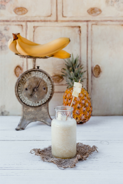 Fresh healthy tropical smoothie on white table - Photo, Image