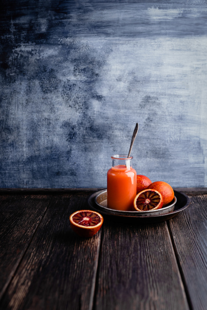 Delicious detox smoothie on rustic wooden board with blood oranges - Photo, Image