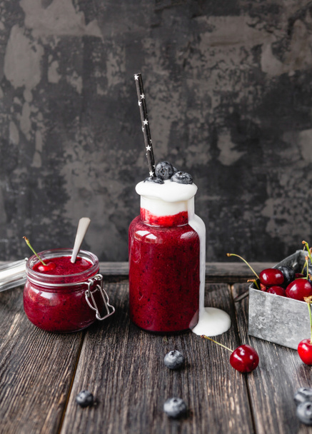 Delicious detox smoothie in bottle and jar on rustic wooden board - Foto, Imagen