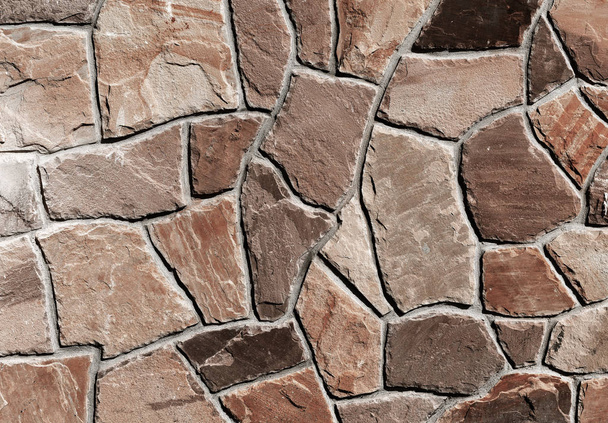 fragment van een muur van een gechipte steen - Foto, afbeelding