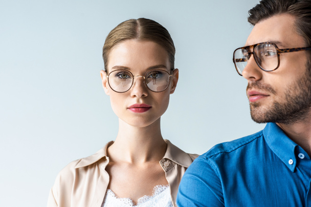 close-up portrait of young man and woman in stylish clothing and eyeglasses isolated on white - Photo, Image