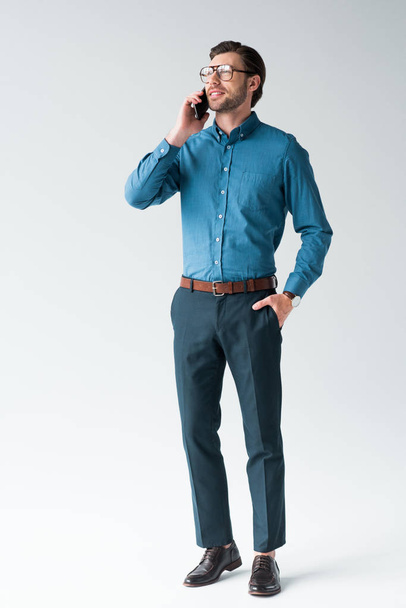 handsome young man talking by phone on white - Foto, imagen