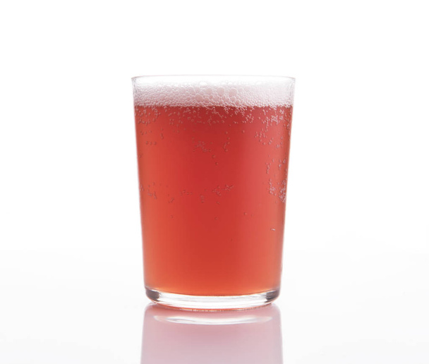 Glass of craft fruit beer on white background. - 写真・画像