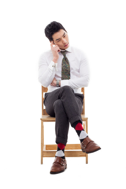 Thinking businessman sitting on the chair. - Photo, image