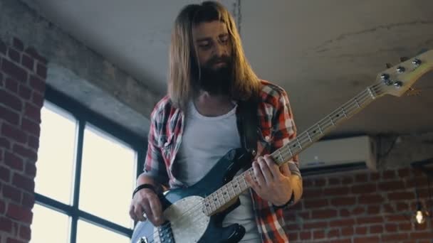 Energetic man playing bass guitar - Footage, Video