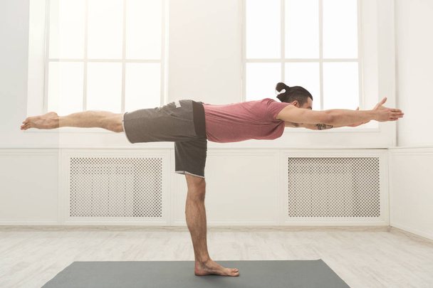 Man stretching hands and legs at gym - Фото, зображення