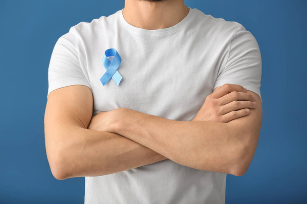 Hombre con cinta azul simbólica sobre fondo de color. Concepto de cáncer de próstata
 - Foto, imagen
