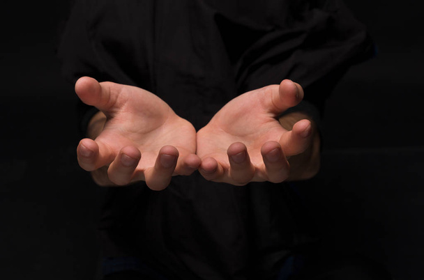 Man keeping hands in cupped shape, cutout on black - Foto, imagen