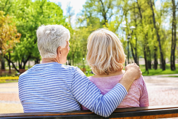 Mature couple resting in park on spring day - Photo, Image