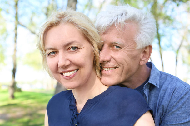 Mature couple resting in park on spring day - Photo, Image