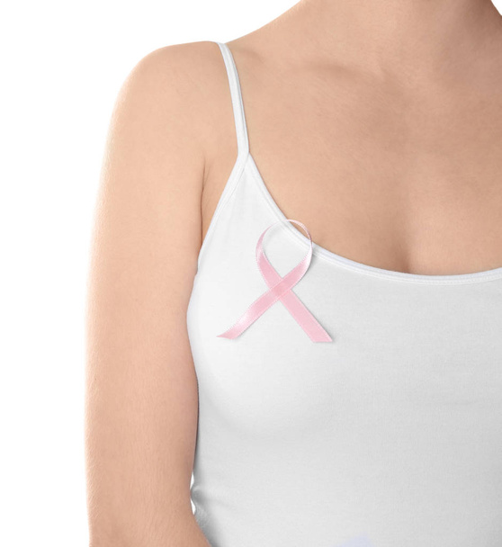 Woman with pink ribbon against white background. Breast cancer awareness concept - Photo, Image