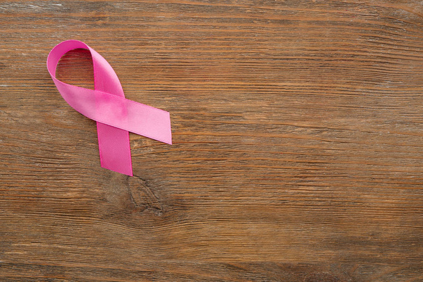 Pink ribbon on wooden background. Breast cancer concept - Zdjęcie, obraz