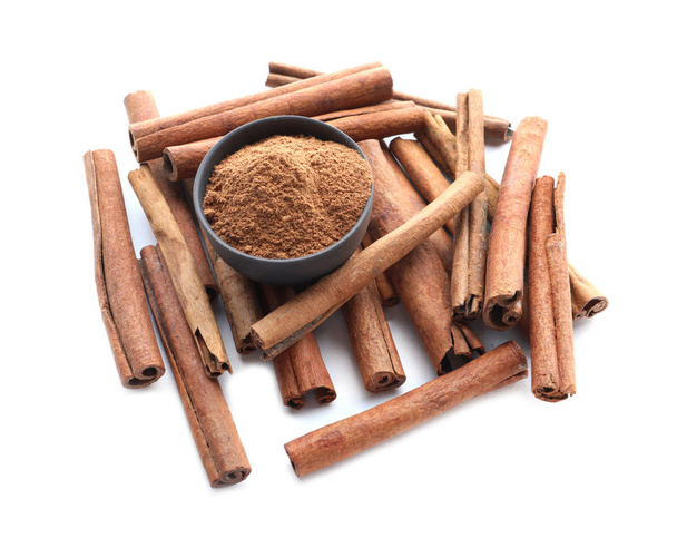 Aromatic cinnamon sticks and powder on white background - Photo, Image