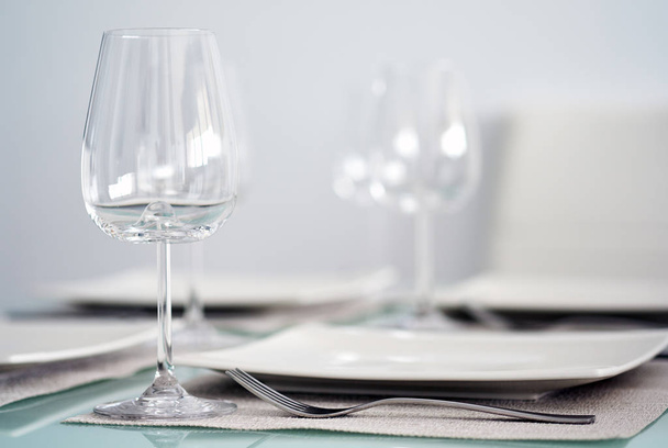 Table setting with a wine glasses, cutlery and plates - Foto, Imagem