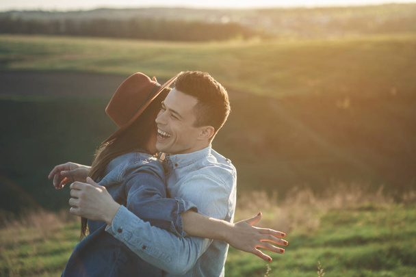 Delighted couple embracing in evening nature - Foto, Imagem
