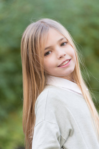 Little girl smile with long blond hair. Child with cute face outdoor. Beauty kid with fresh look and skin. Beauty look and skincare. Happy childhood and childcare - 写真・画像