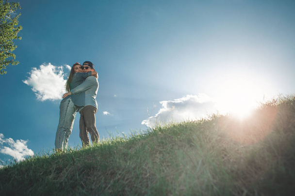 Embracing couple on green meadow - 写真・画像