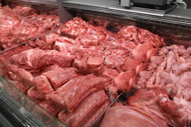 Refrigerated display case with fresh meat in butcher shop - Fotografie, Obrázek