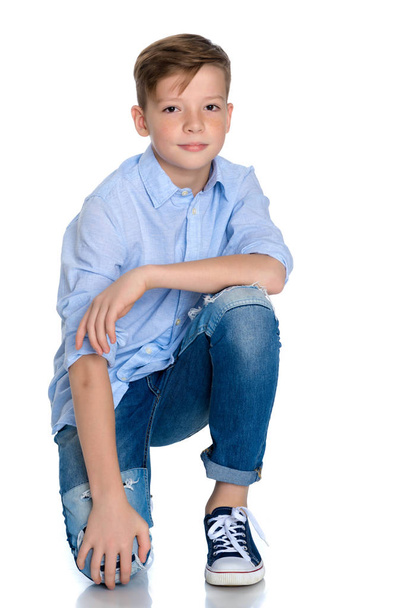 Fashionable boy teen sitting on the floor. - Photo, image