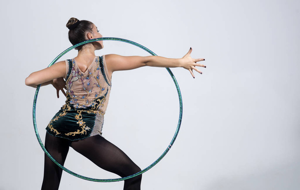 brunette woman doing exercise with a hula-hoop. Fitness woman - Фото, зображення