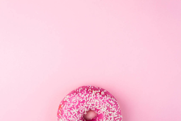 Pink glazed donut on pink pastel background - Fotoğraf, Görsel