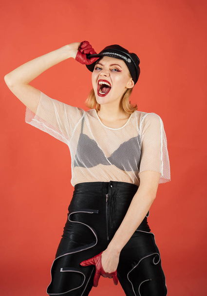 Cool woman shouting on red studio wall background. - Foto, afbeelding
