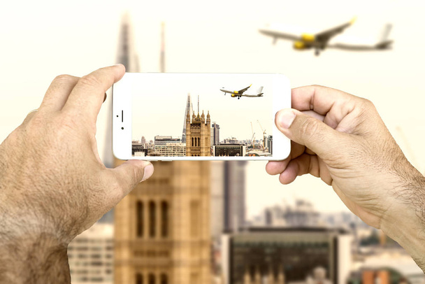 human hands taking photo of skyline of London with smartphone - Photo, Image