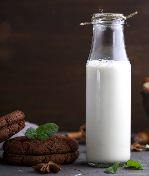 full glass bottle with milk and round chocolate biscuits - Photo, Image