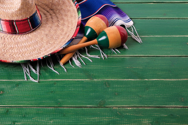 Mexico cinco de mayo wood background sombrero serape blanket maracas - 写真・画像