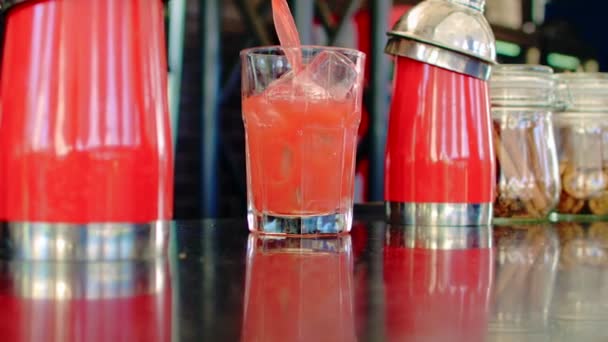 Red cocktail poured into a glass - Footage, Video