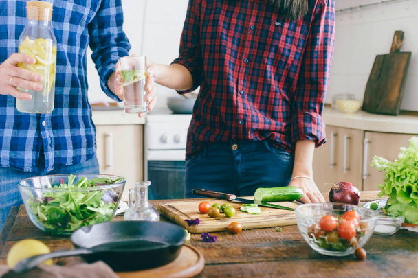 Couple is preparing healthy light dinner at home in the kitchen. Healthy food concept - Fotoğraf, Görsel