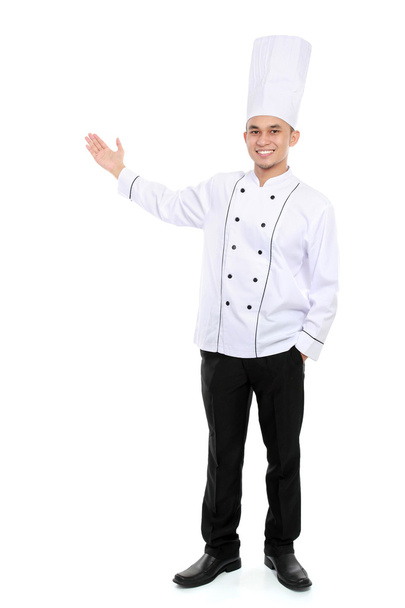 male chef smiling presenting blank space - Foto, Imagen