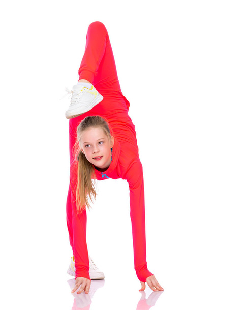 The gymnast perform an acrobatic element. - Zdjęcie, obraz