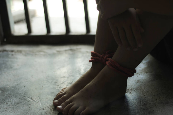 Niño secuestrado atado con cuerda y encerrado en una jaula de acero. dejar de abusar de la violencia.concepto de secuestro, violencia, aterrorizado, derechos humanos
 - Foto, Imagen
