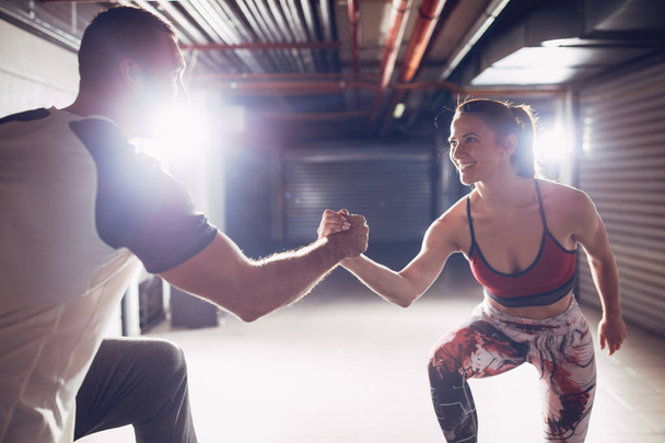 Young muscular couple after hard workout giving high five - Photo, Image